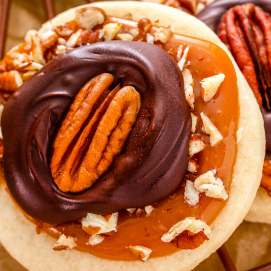 A close up of a Turtle Cookie with pecans, caramel, and chocolate.