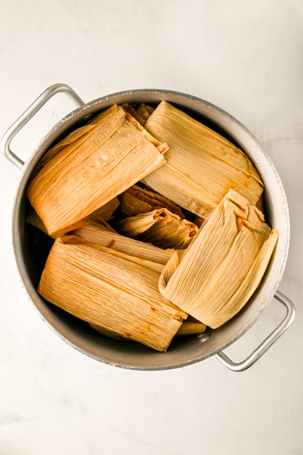 Assembling the tamales in the steamer basket before cooking. 