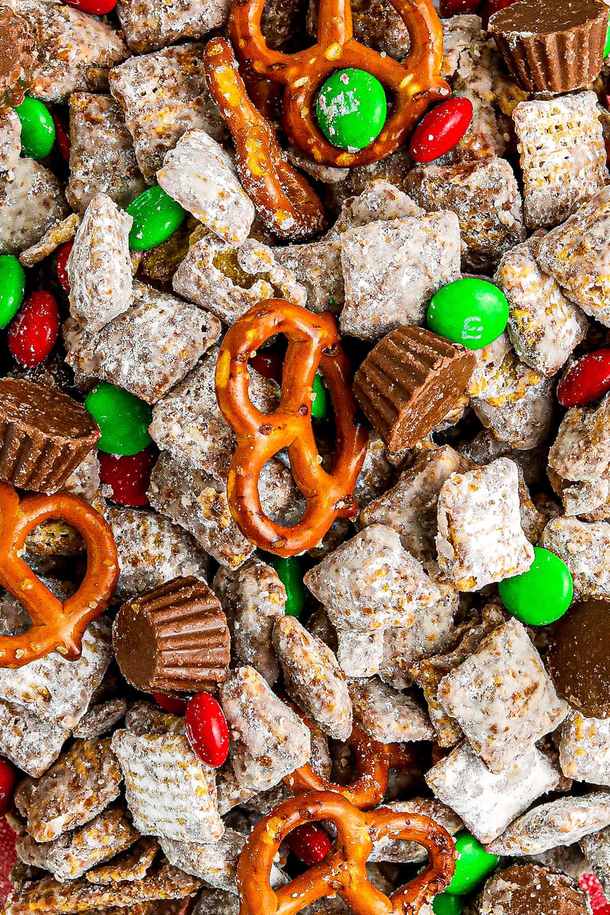Close-up of pretzels, Reese's, and M&M's in Christmas puppy chow. 