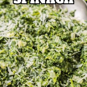 A bowl filled with the best creamed spinach with fresh parmesan on top.