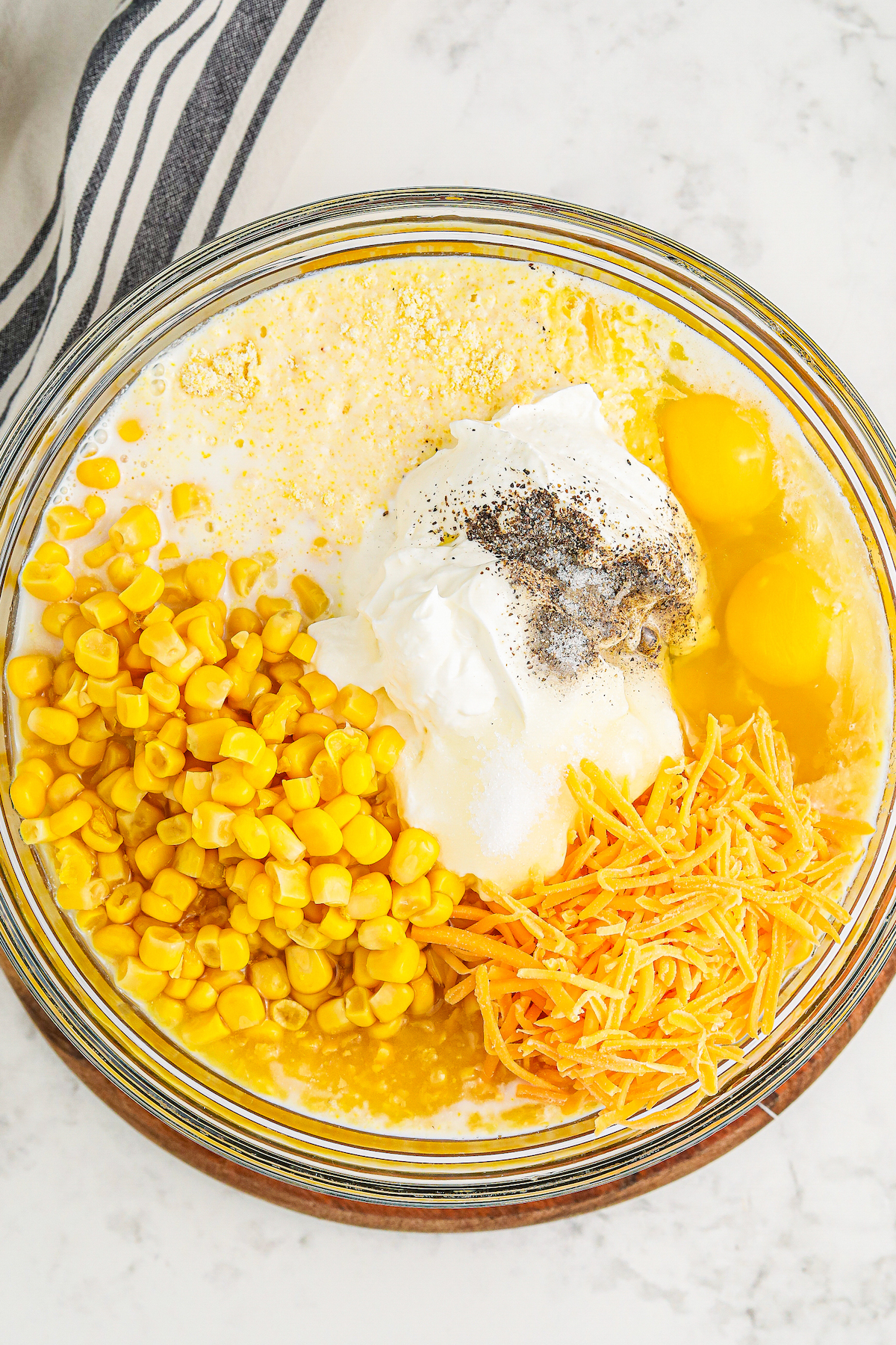 All ingredients for jiffy corn casserole recipe added to a mixing bowl.