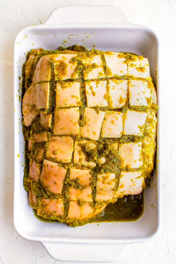 Fat layer on top of the pork shoulder cut into squares with the marinade pressed into it.