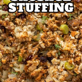 Close up image of sausage stuffing with fresh herbs and dried cranberries.