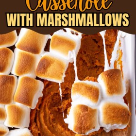 Sweet potato casserole in a baking dish with a wooden spoon scooping out a serving showing the toasted marshmallows all melted on top.