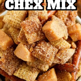 A bowl of Churro Chex mix coated in cinnamon sugar with caramel squares and pretzels.