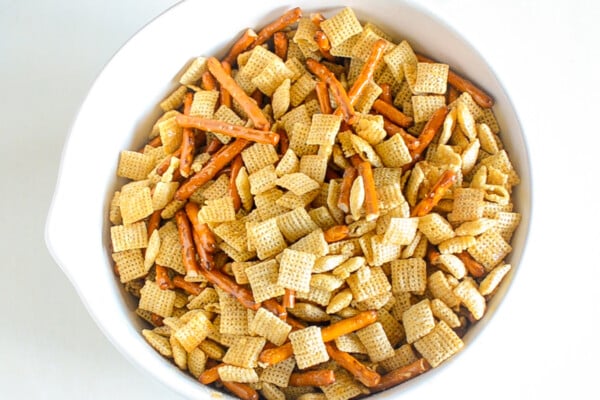 A bowl of Chex mix cereal and pretzels tossed together.