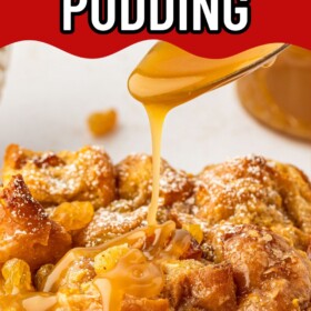 A slice of donut bread pudding on a plate with rum sauce being poured on top.