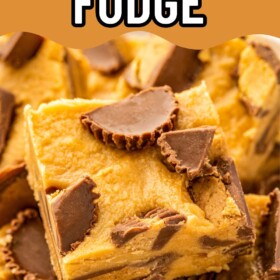 Squares of microwave peanut butter fudge with Reese's cups stacked on top of each other.