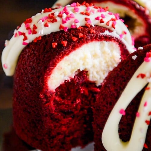 A slice of red velvet cream cheese bundt cake being lifted with a cake server.