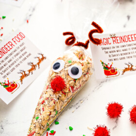 Reindeer food in a cone treat bag decorated like Rudolph with googly eyes, pipe cleaner antlers and a red pom pom nose.