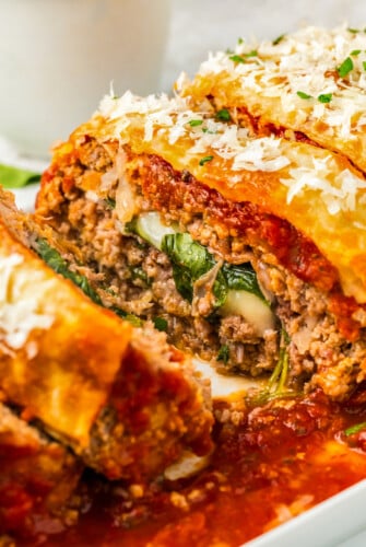 Sliced Italian meatloaf close-up with melty cheese and marinara sauce.