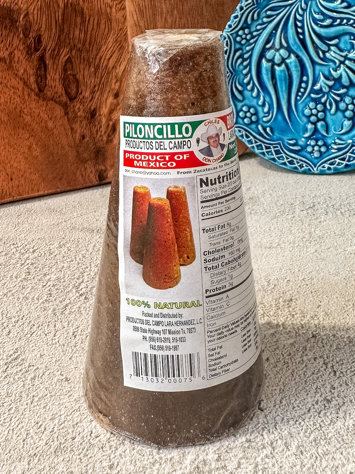 A wrapped Piloncillo cone with a brand label on it.