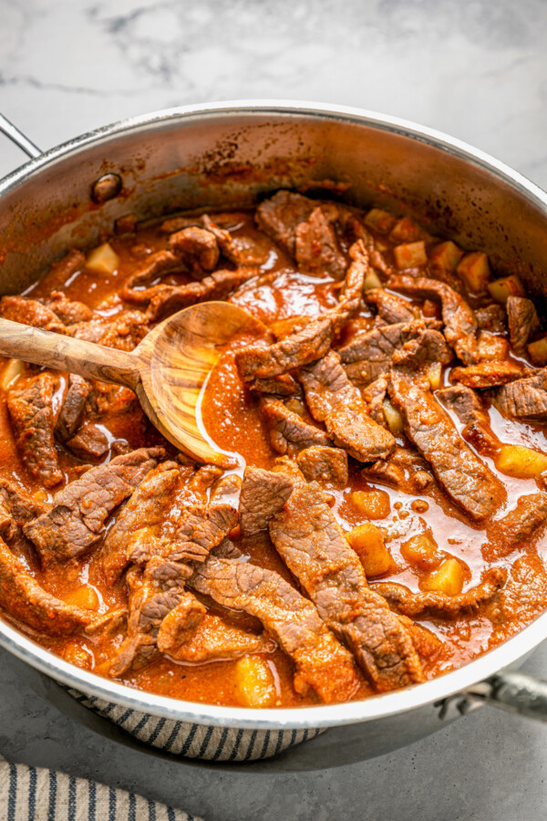 Strips of beef and cubed potatoes simmering in ranchero sauce.