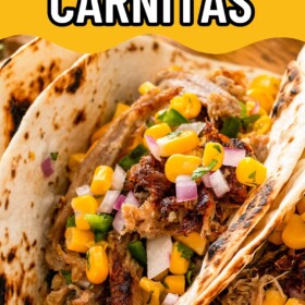 Shredded carnitas topped with fresh salsa in tortillas.
