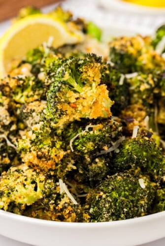 Bowl of parmesan roasted broccoli with red pepper flakes.