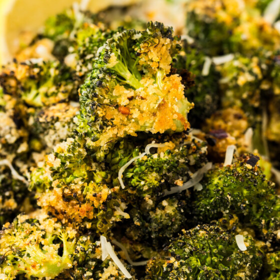 Bowl of parmesan roasted broccoli with red pepper flakes.