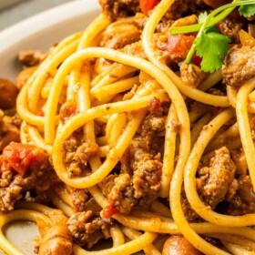 Meaty and hearty cowboy spaghetti with pinto beans and rotel on a plate.