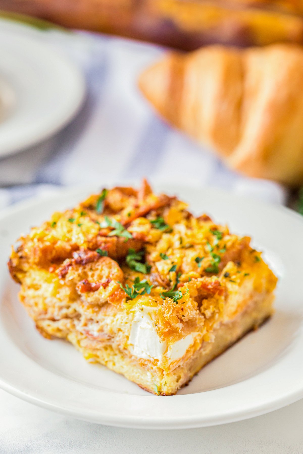 A slice of Breakfast Casserole With Ham and cream cheese on a plate.