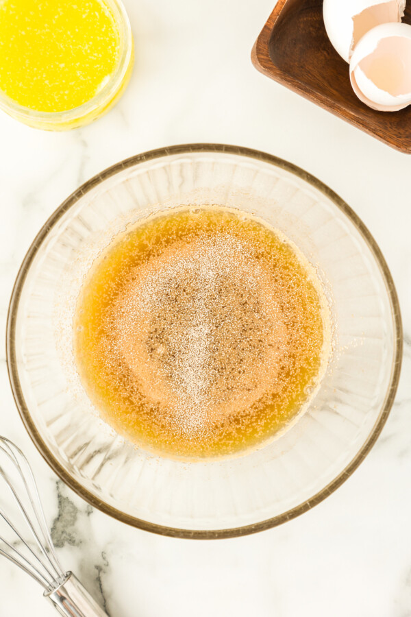 Yeast, pineapple juice, brown sugar and granulated sugar in a bowl.