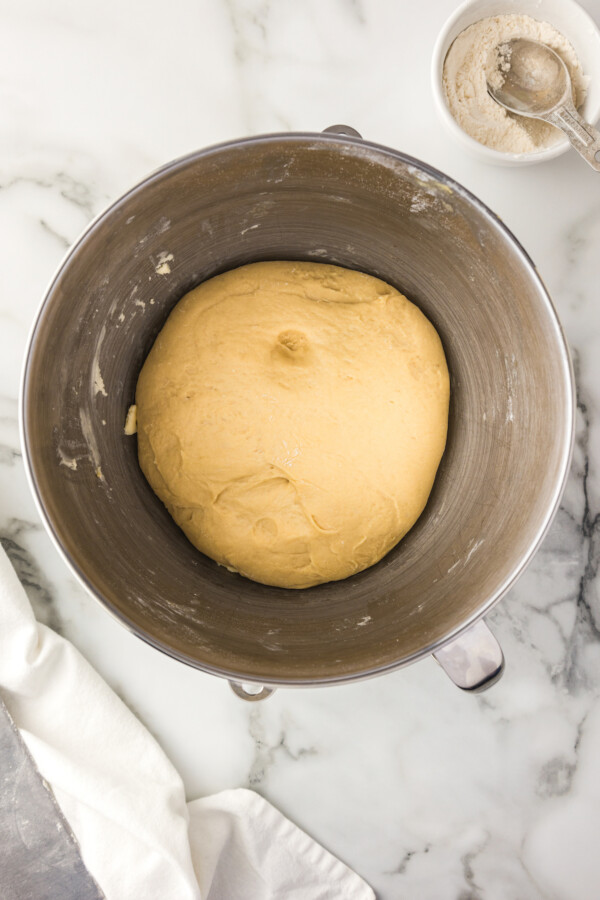 Yeast dough for rolls that has risen in a bowl.