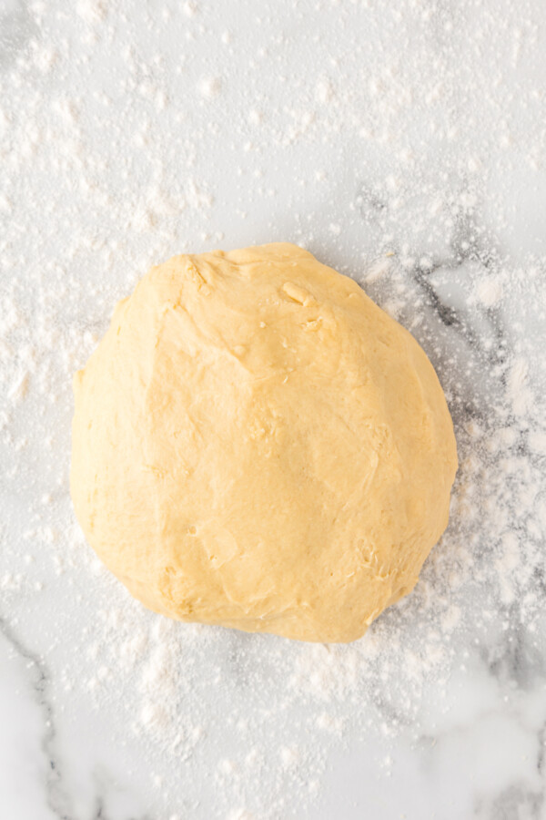Sweet yeast dough on a floured countertop.