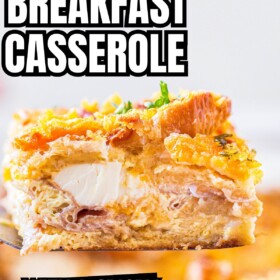Overnight Breakfast Casserole with Ham being lifted with a spatula out of a baking dish.