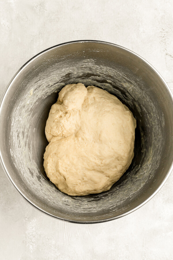 Homemade pretzel dough in a mixing bowl before rising.