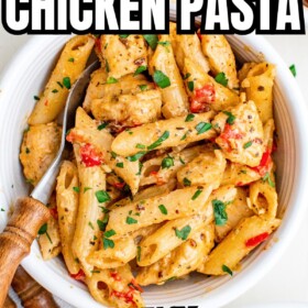 A bowl of creamy Cajun Chicken Pasta with fresh herbs on top.