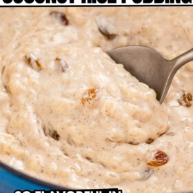 A serving spoon scooping into a pot of creamy coconut rice pudding with golden raisins.