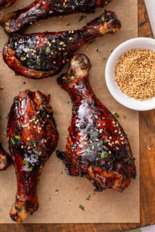 Tender Asian baked drumsticks with a sweet and sticky marinade topped with fresh herbs and sesame seeds.