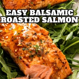 Balsamic salmon on a plate with arugula and a fork cutting a bite.