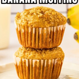 Two freshly baked brown sugar banana muffins stacked on top of each other on a plate.