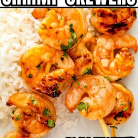Grilled Shrimp Skewers served on a plate over white rice.