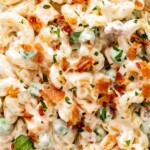 Bacon Ranch Pasta Salad in a bowl topped with crispy bacon.