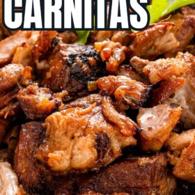 Juicy, tender and crispy pork carnitas in a serving bowl topped with fresh cilantro.