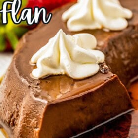 Creamy chocolate flan in a rich caramel sauce on a plate topped with whipped cream and strawberries.