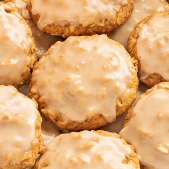 Landscape photo of iced pumpkin oatmeal cookies on a plate.