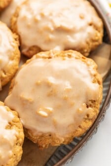 Cinnamon icing coats the tops of pumpkin oatmeal cookies.