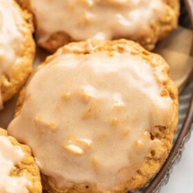 Cinnamon icing coats the tops of pumpkin oatmeal cookies.