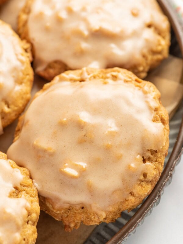 Cinnamon icing coats the tops of pumpkin oatmeal cookies.