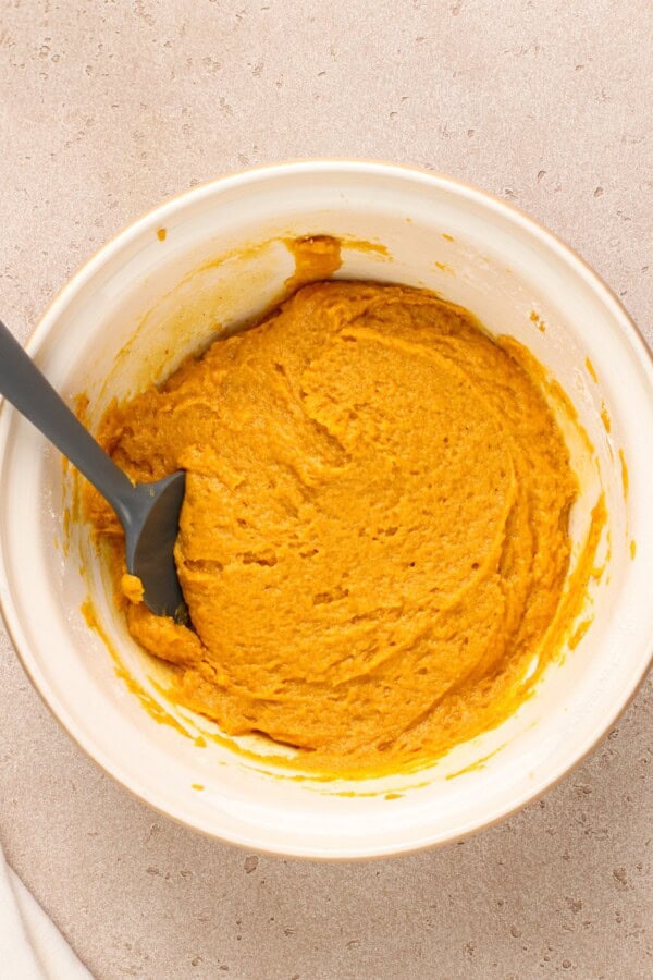 Cookie dough mixed in a large white bowl.