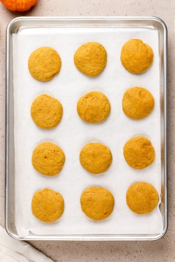 Baked pumpkin cookies on a baking sheet.