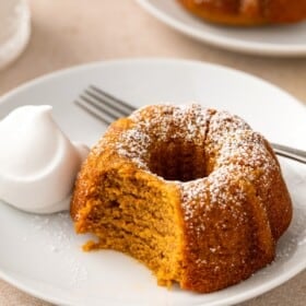 A bite has been taken out of a moist pumpkin bundt cake.