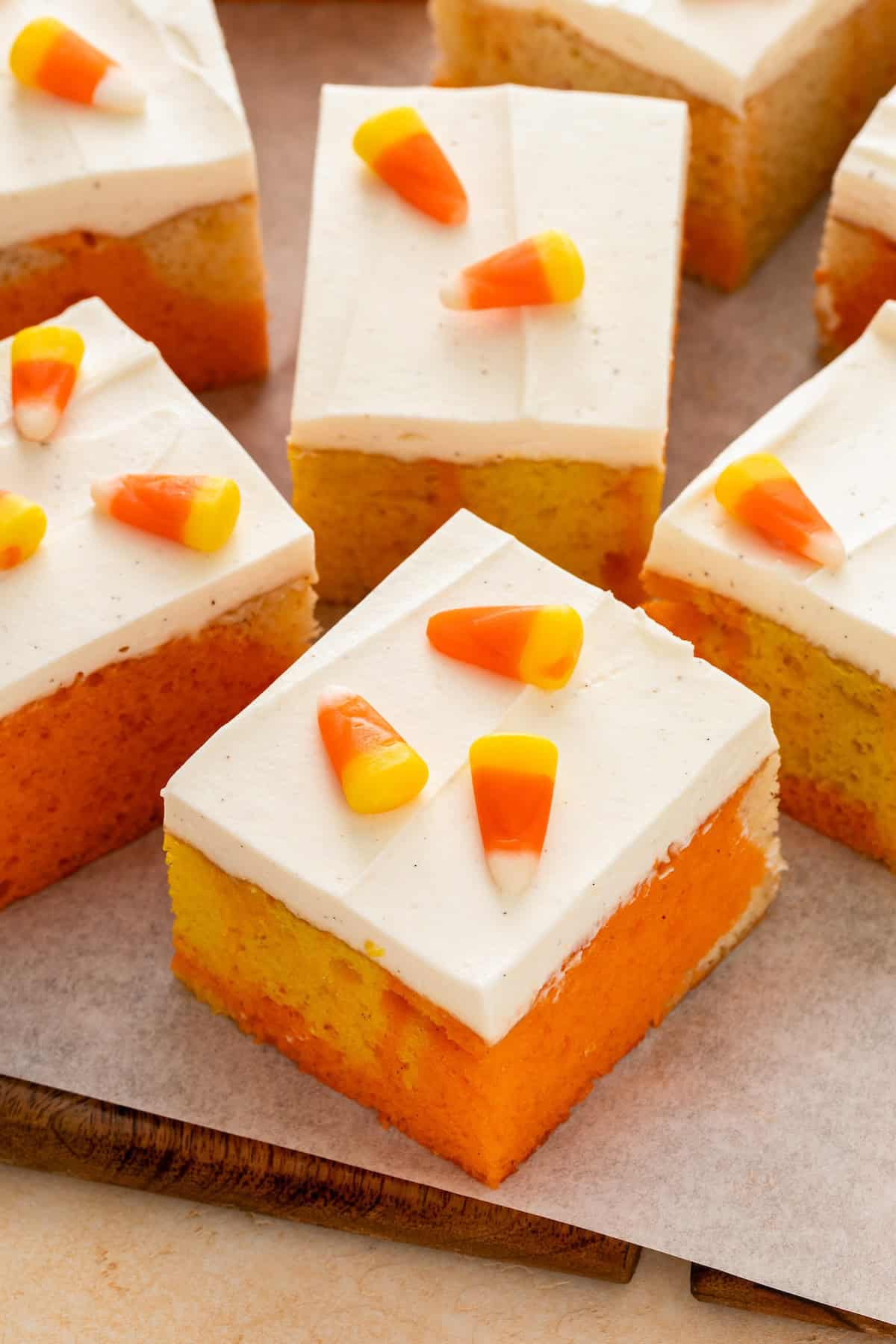 Frosted candy corn cake squares garnished with candies.