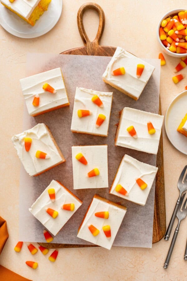 Squares of frosted halloween cake topped with candy corn.