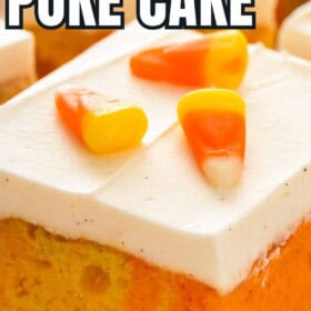 Vibrant candy corn cake topped with whipped cream cheese frosting and candy.