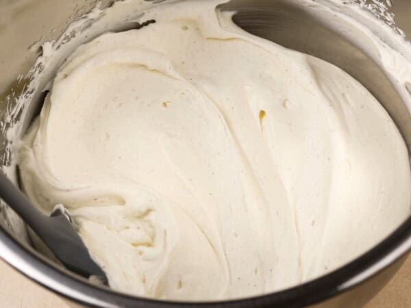 Cream cheese frosting presented in a large bowl.