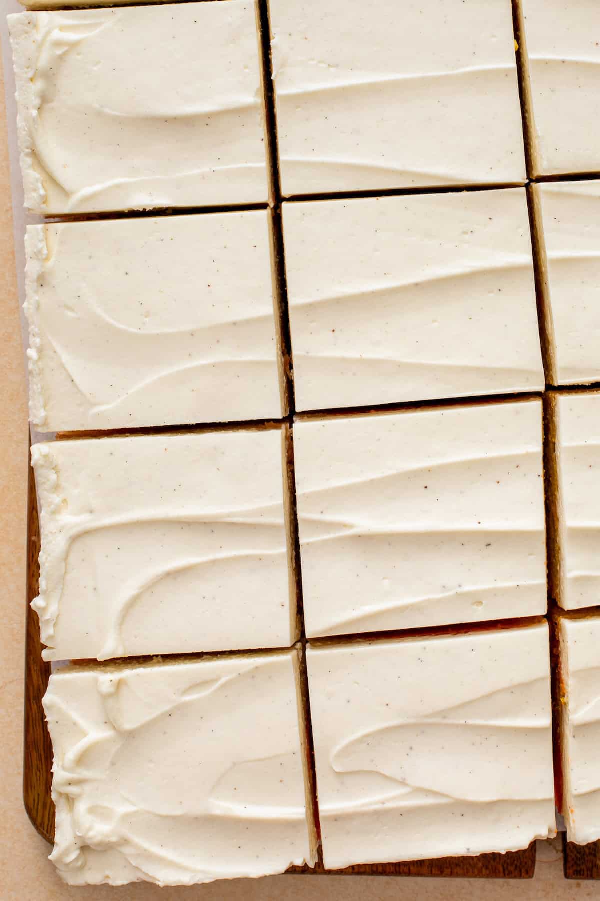 Slices of cake topped with cream cheese whipped frosting.