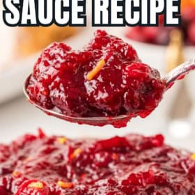 A spoon lifting a serving of cranberry sauce recipe with orange zest out of a bowl.