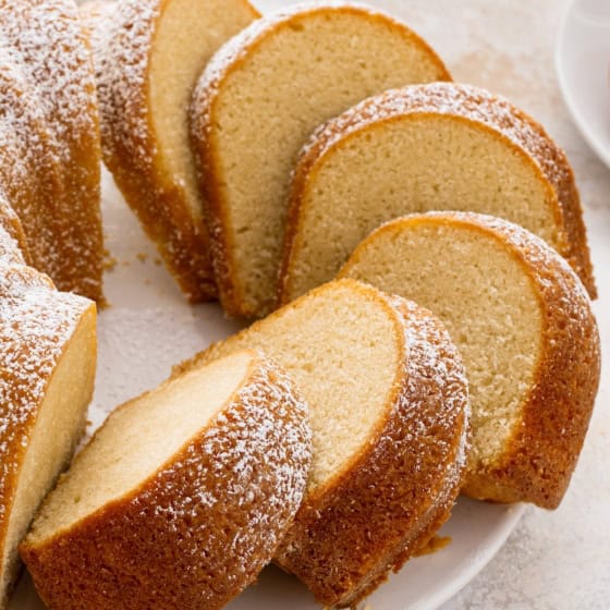 Buttermilk pound cake sliced into pieces dusted with powdered sugar on top.